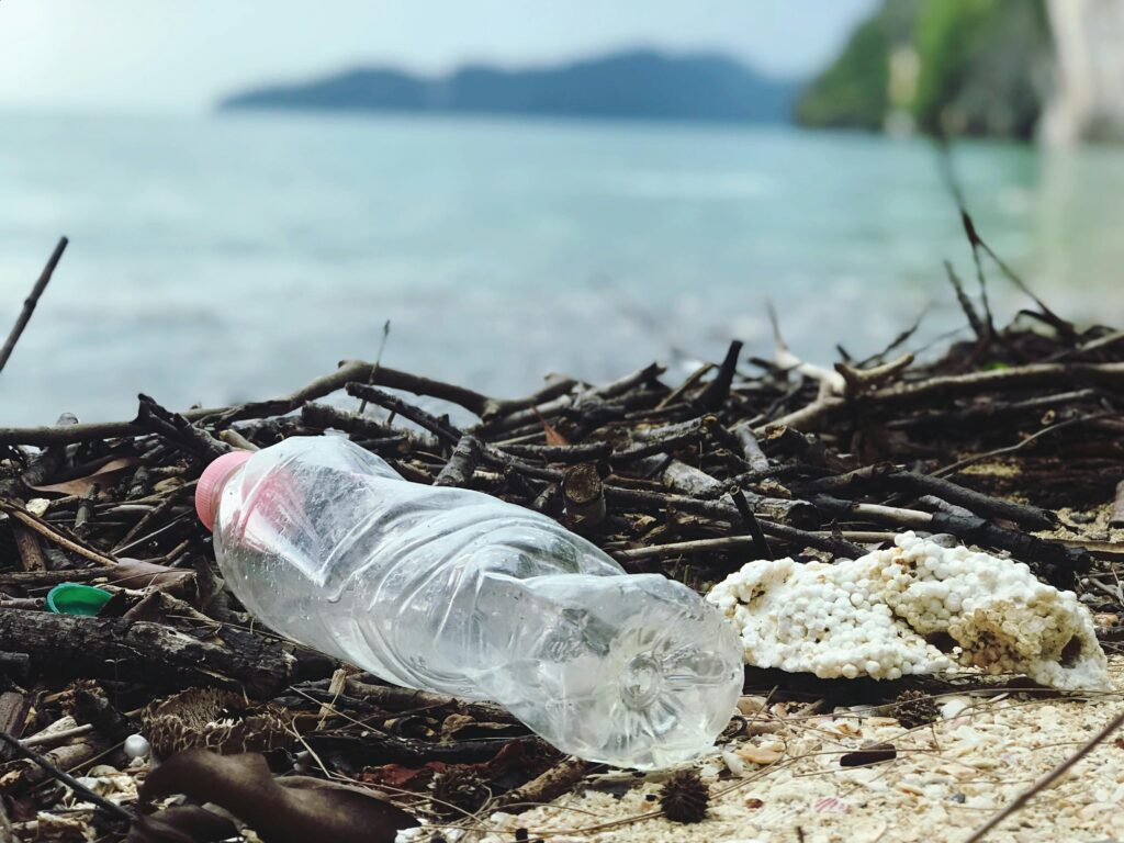 pexels-photo-2409022-2409022 Discarded plastic bottle on a Malaysian beach, highlighting environmental pollution.